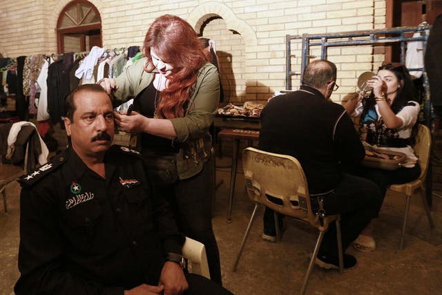 Iraqi actors prepare to perform their roles in "The Hotel," at a filming location in Baghdad, Iraq