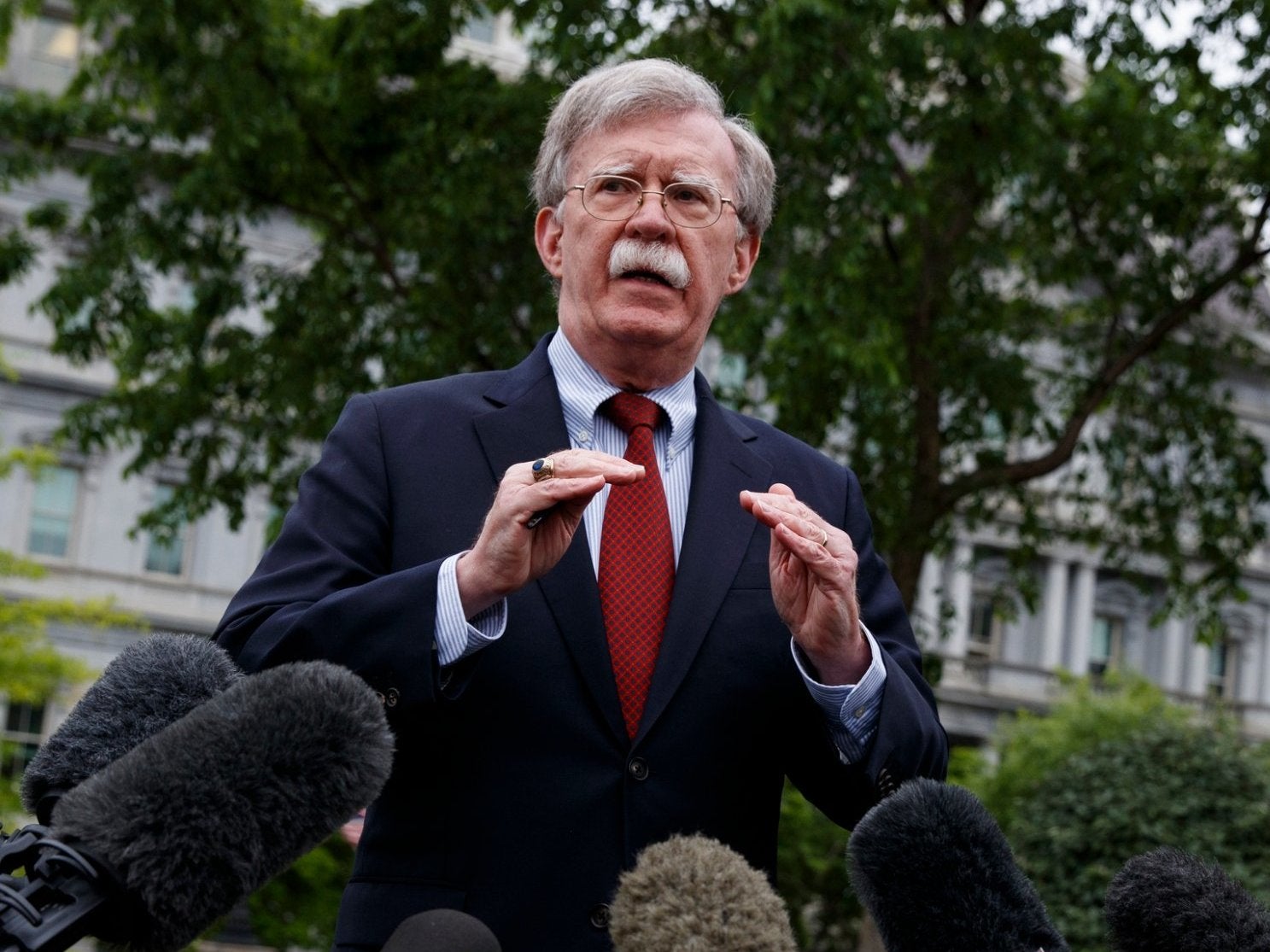 In this May 1, 2019, file photo, National security adviser John Bolton talks to reporters about Venezuela, outside the White House
