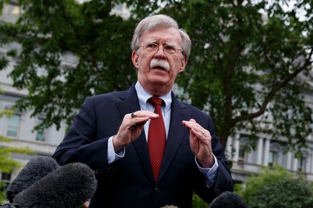 In this May 1, 2019, file photo, National security adviser John Bolton talks to reporters about Venezuela, outside the White House