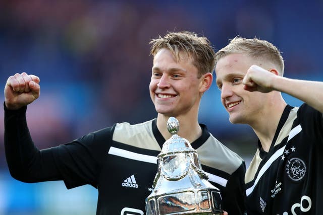 Frenkie de Jong and Donny van de Beek celebrate with the trophy