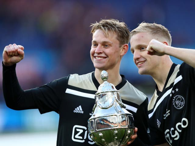 Frenkie de Jong and Donny van de Beek celebrate with the trophy