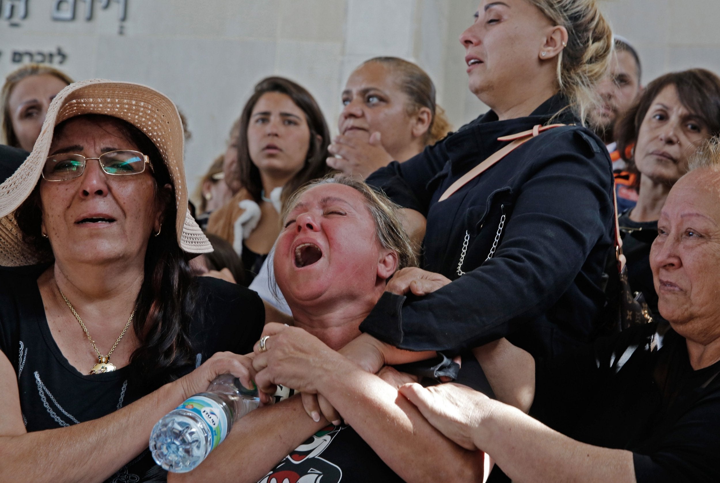 Relatives mourn during the funeral of Israeli Moshe Agadi at a cemetery in the southern Israeli town of Ashkelon near the Gaza border on May 5, 2019