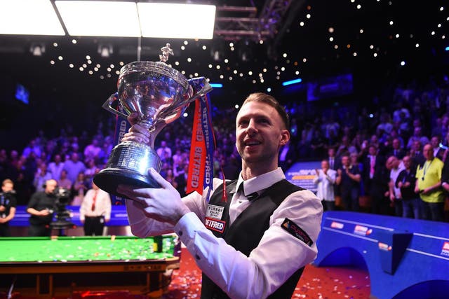 Judd Trump celebrates with the World Championship trophy