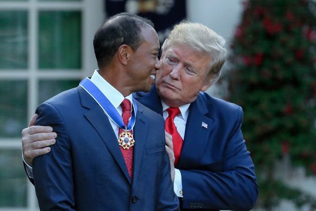 Donald Trump presents the Presidential Medal of Freedom to Tiger Woods at the White House.
