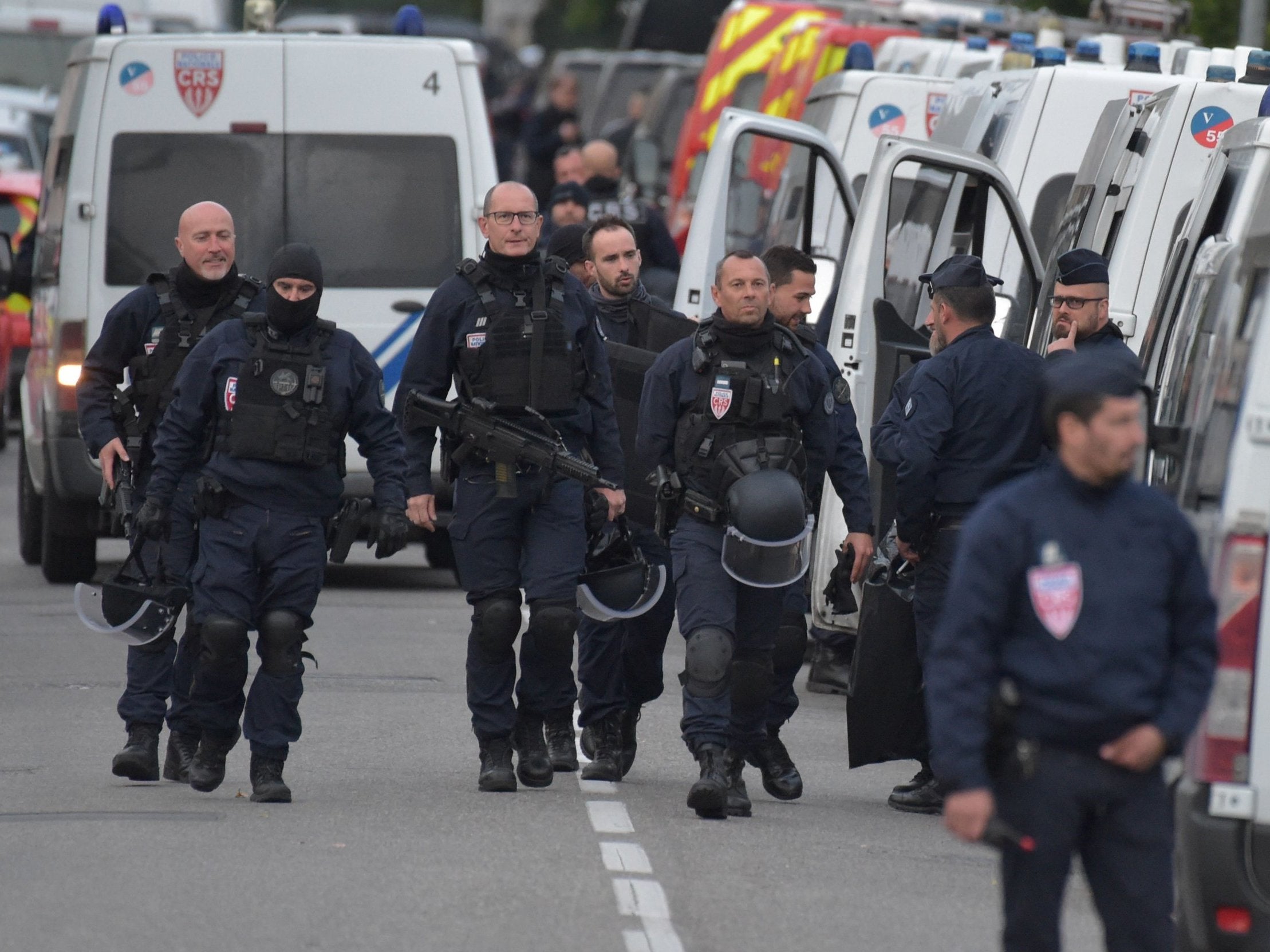 Policemen near the convenience store where a man is holding several hostages