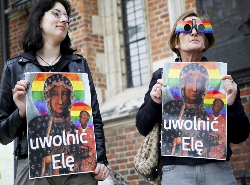 About 300 people with a giant rainbow flag and holding posters of the altered icon listened to speeches from human rights activists at a protest in the Polish capital of Warsaw