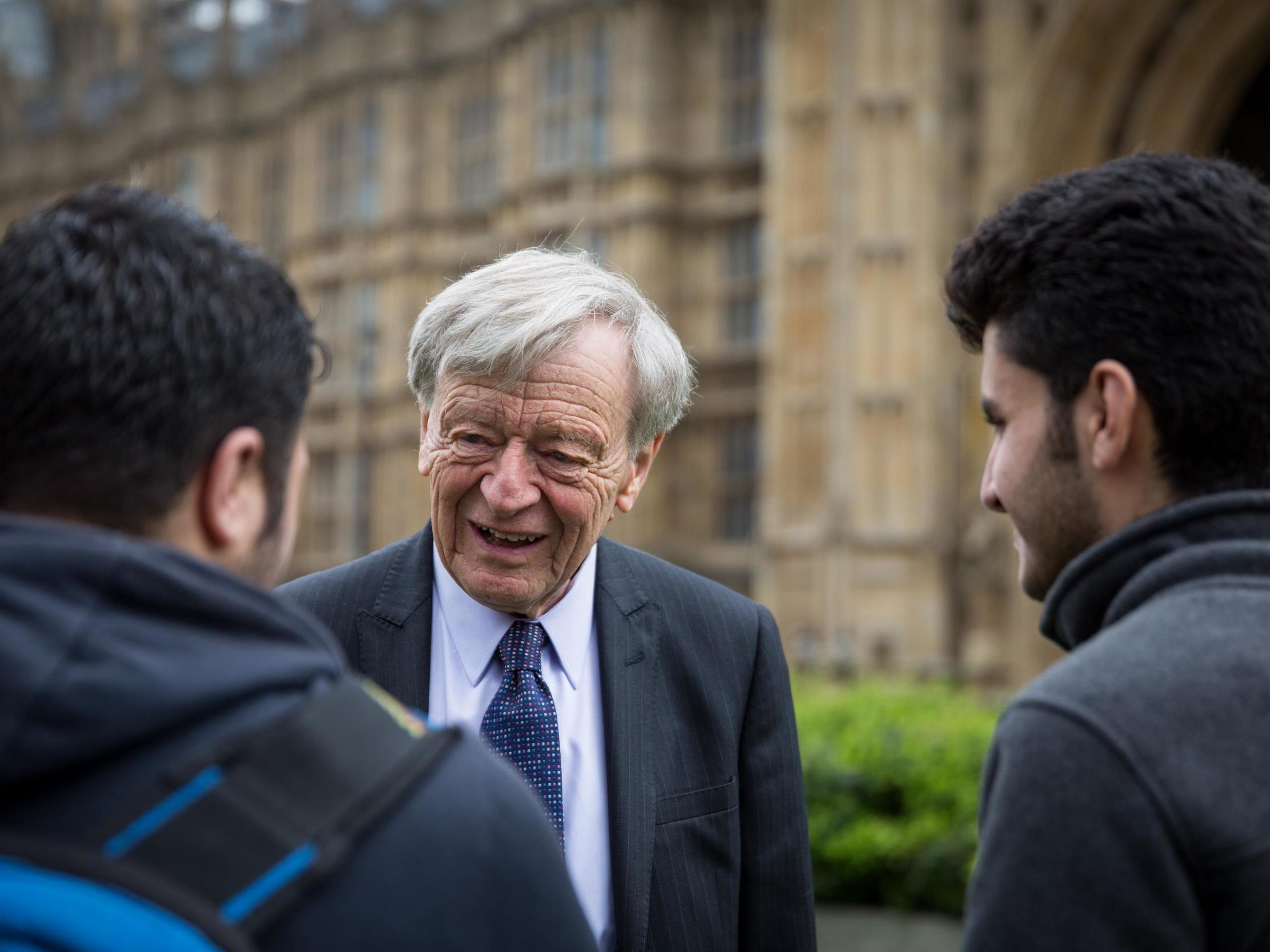 Lord Alf Dubs speaks to two child refugees from Syria