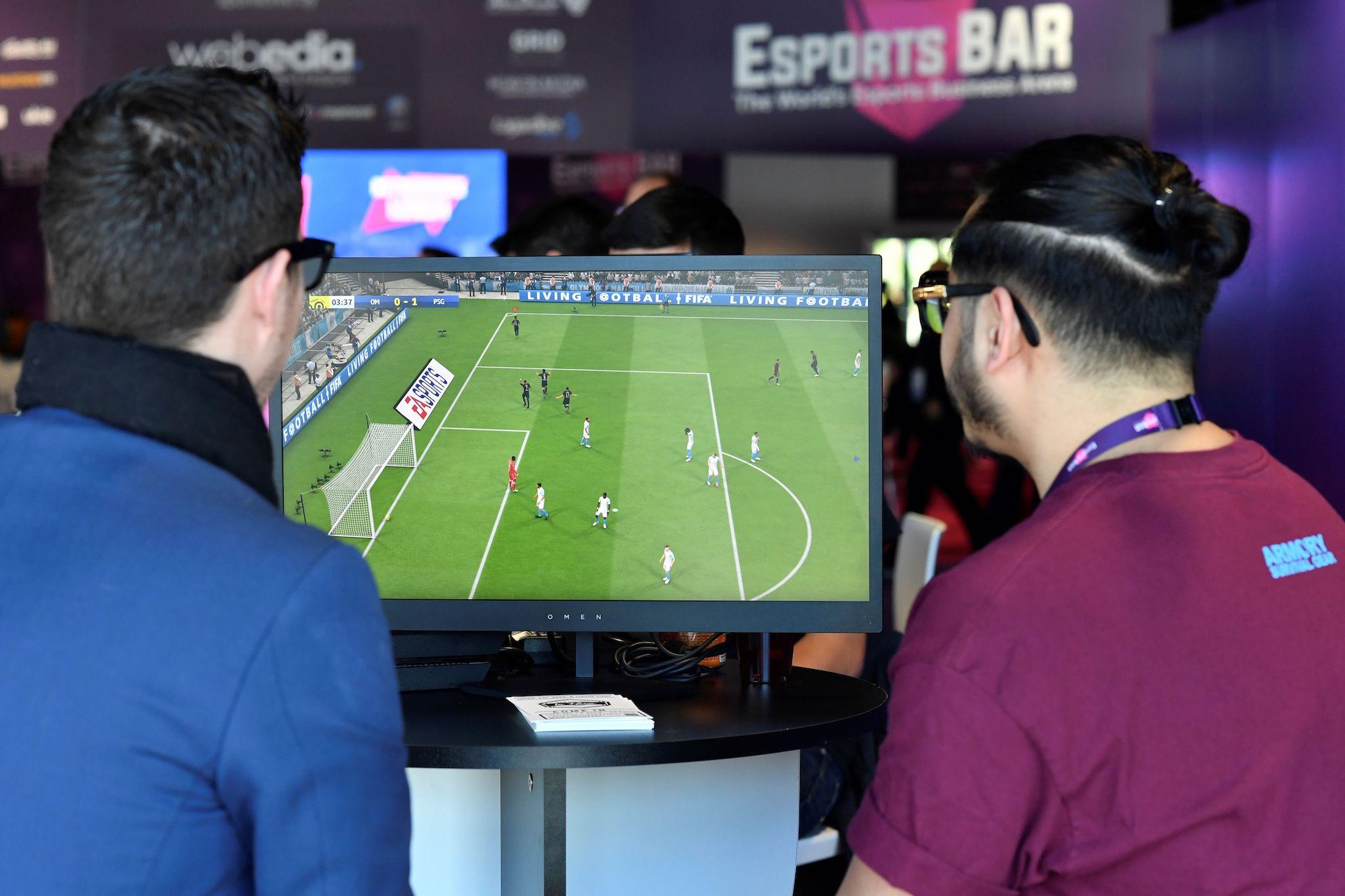 Visitors plays on EA Vancouver video game developer's football simulation video game FIFA 19 at the eSports Bar trade fair in Cannes, southern France on February 13, 2019