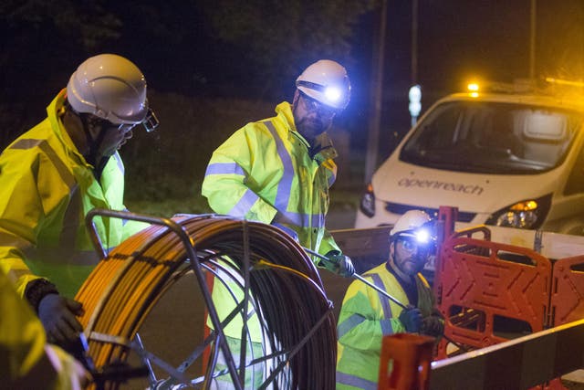 Cabling up under floodlights: BT has promised to speed up fibre broadband connections while maintaining its dividend