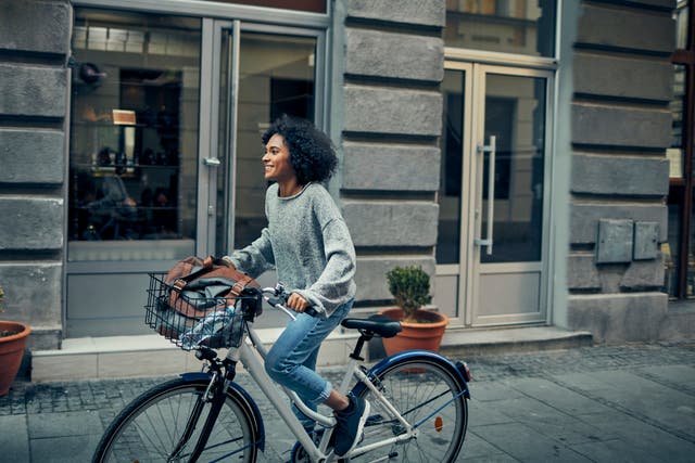 Woman Riding Rented Bicycle In A City