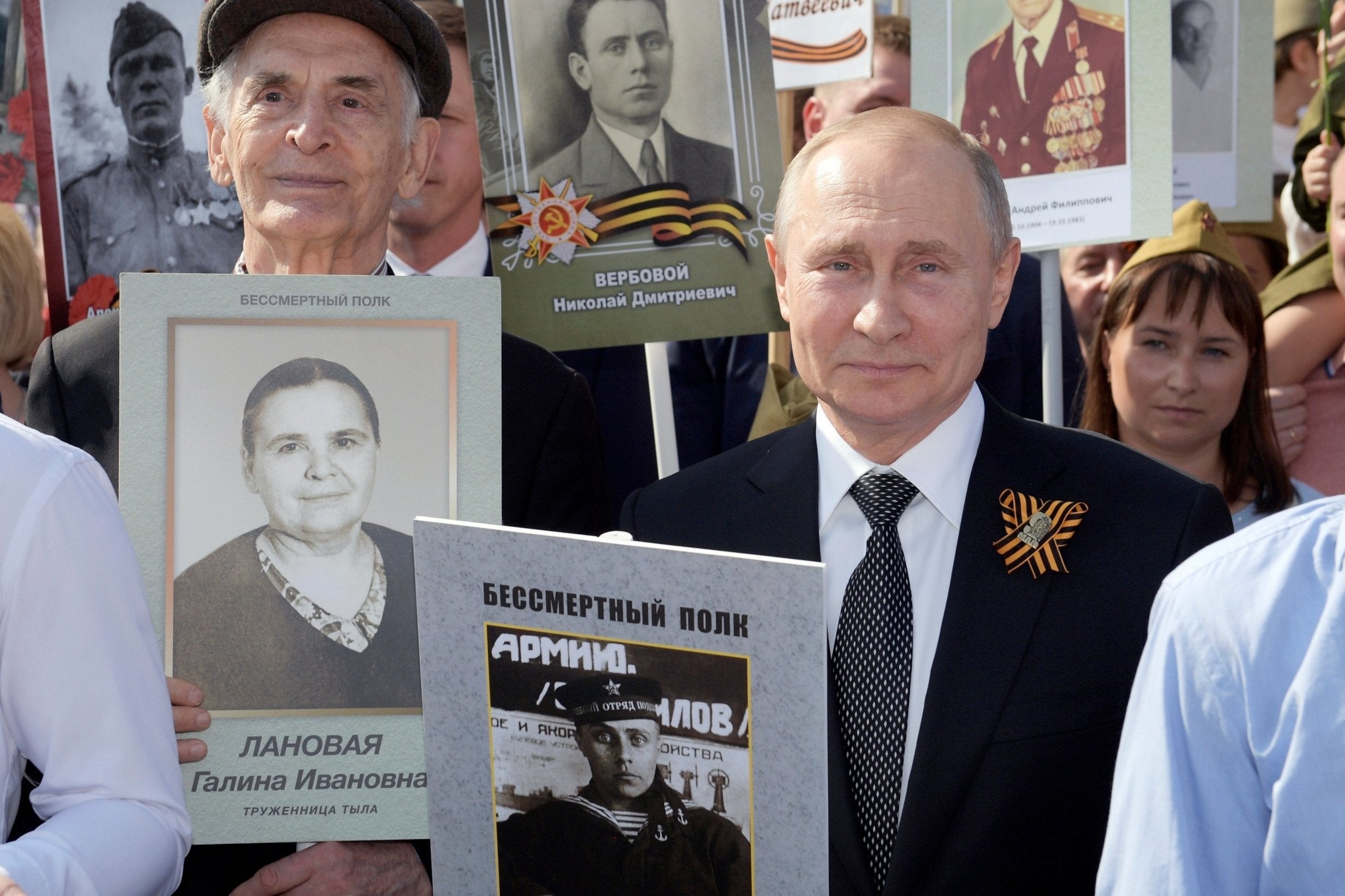 Vladimir Putin holds a portrait of his father Vladimir Spiridonovich during Victory Day