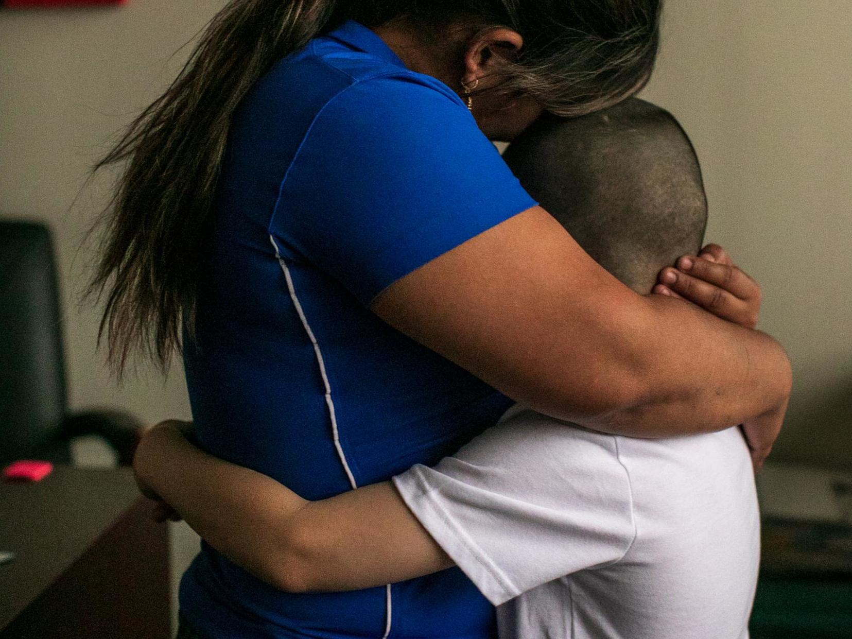 Patricia and her son, Jose, 8, from Honduras, in their lawyer's office in Bryan, Texas