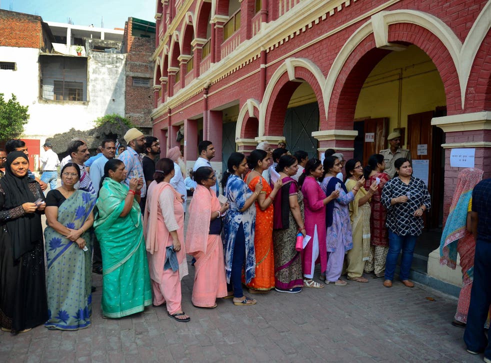 Voters queue at a polling station in Allahabad, Uttar Pradesh state