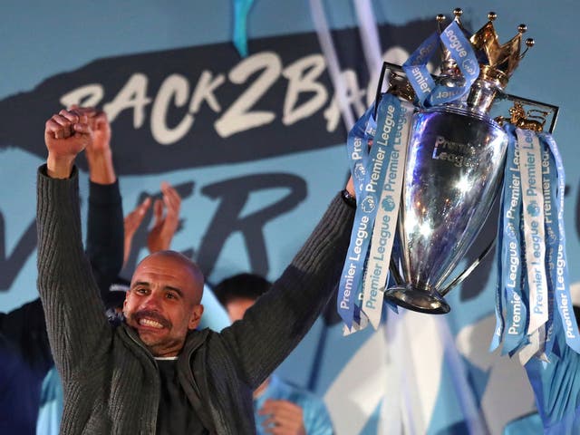 Pep Guardiola celebrates with the Premier League trophy