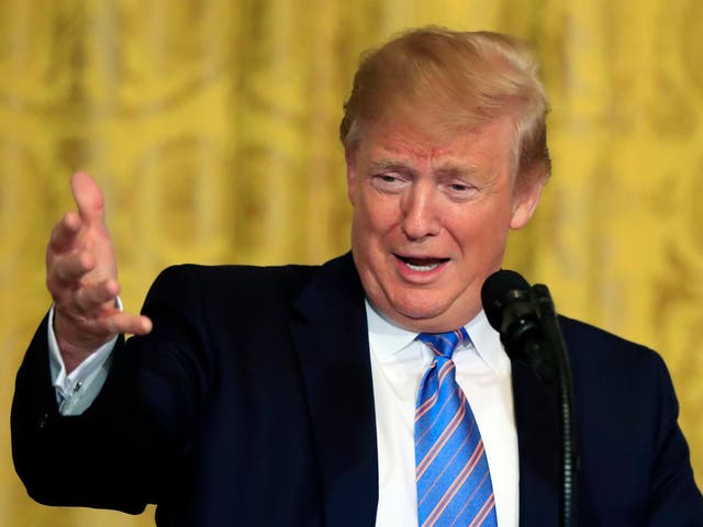 President Donald Trump speaks during a celebration of military mothers with first lady Melania Trump in the East Room of the White House in Washington on Friday 10 May 2019