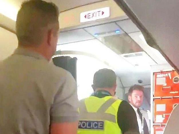 A rugby player was taken off a plane after delaying it for over 90 minutes for engaging in anti-social behaviour and allegedly sexually harassing a female crew member.