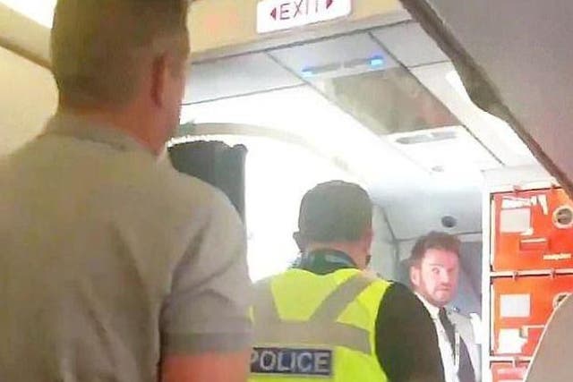 A rugby player was taken off a plane after delaying it for over 90 minutes for engaging in anti-social behaviour and allegedly sexually harassing a female crew member.