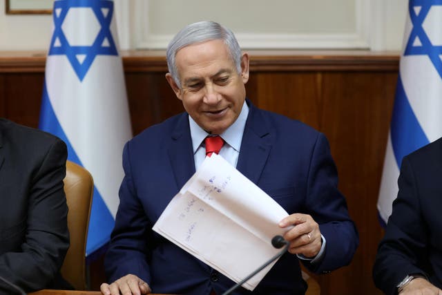 Israeli prime minister Benjamin Netanyahu holds a paper at the start of the weekly cabinet meeting at his Jerusalem office on 12 May