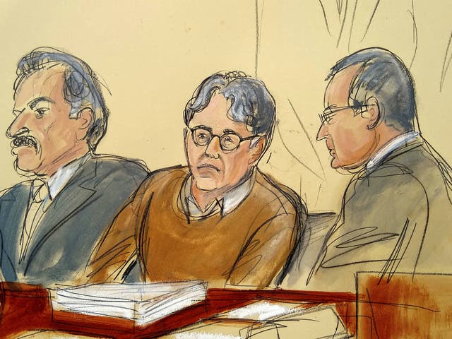 In this courtroom drawing, defendant Keith Raniere, centre, is seated between his lawyers