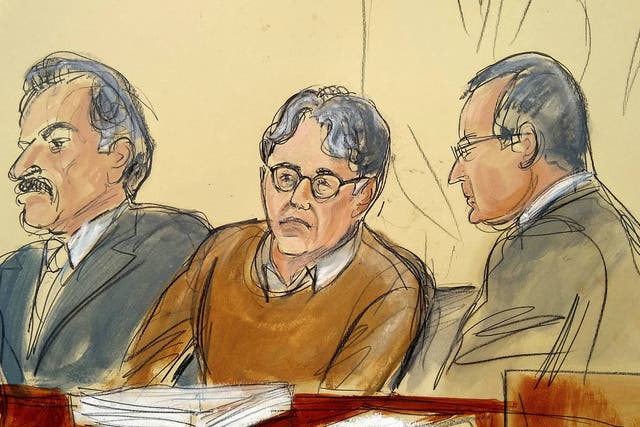 In this courtroom drawing, defendant Keith Raniere, centre, is seated between his lawyers