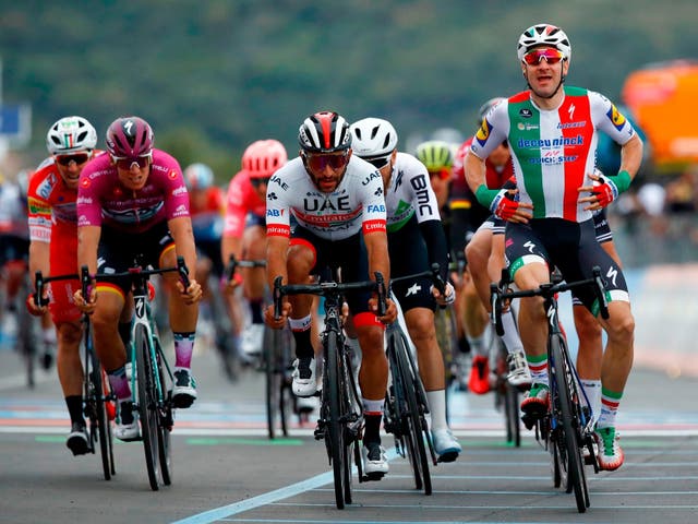 Elia Viviani, right, lost his victory to Fernando Gaviria, centre