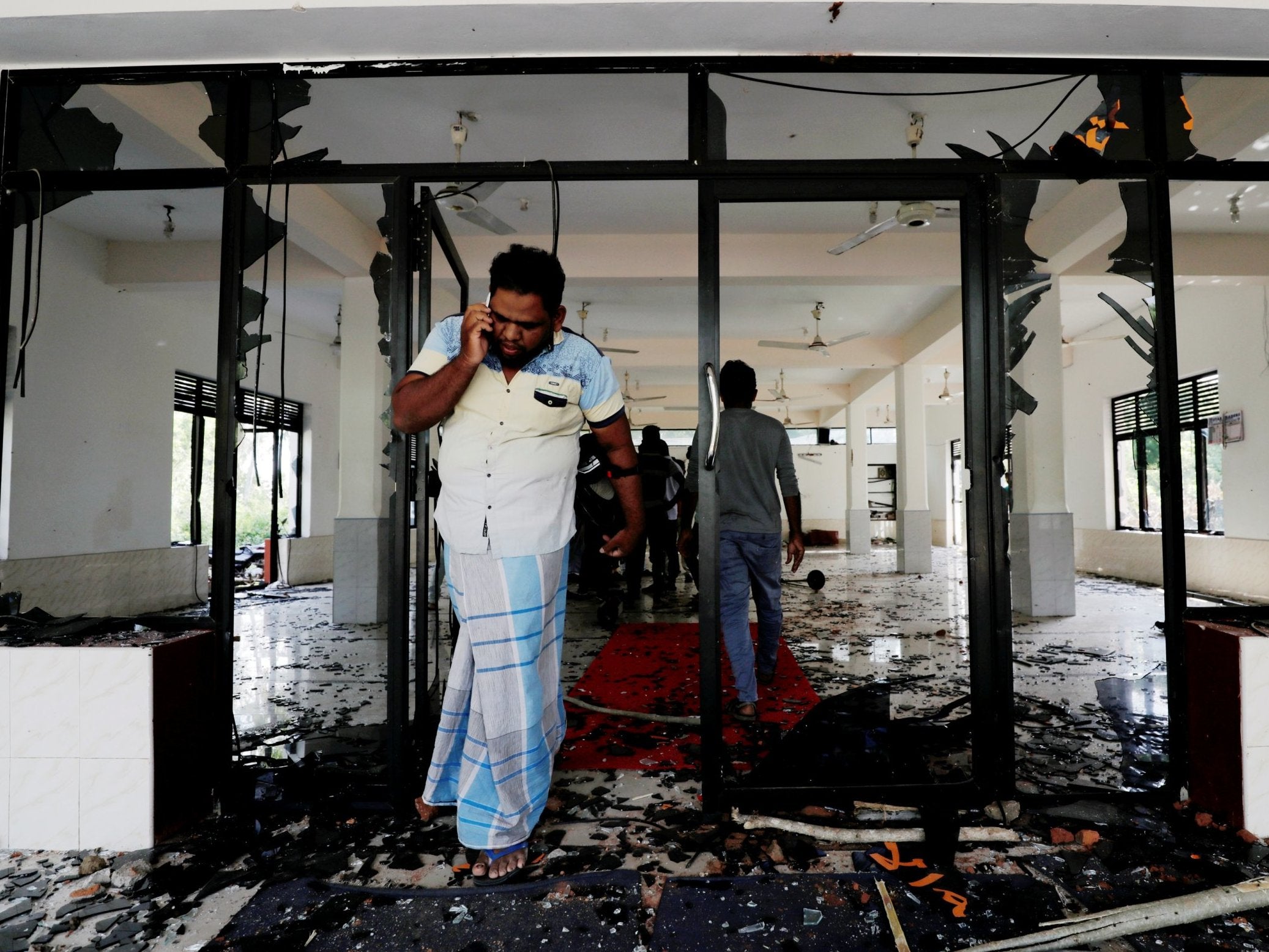 A Muslim man stands inside a mosque after a mob attack in Sri Lanka