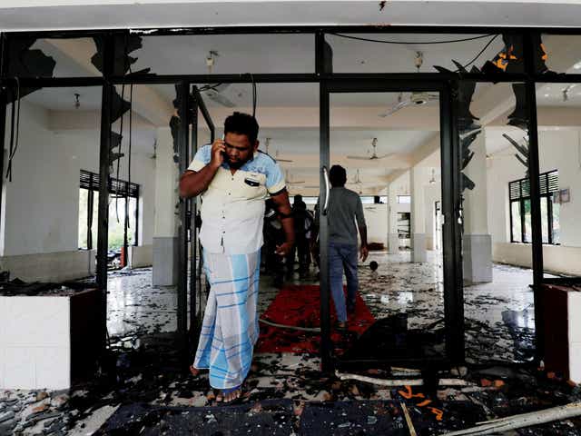 A Muslim man stands inside a mosque after a mob attack in Sri Lanka