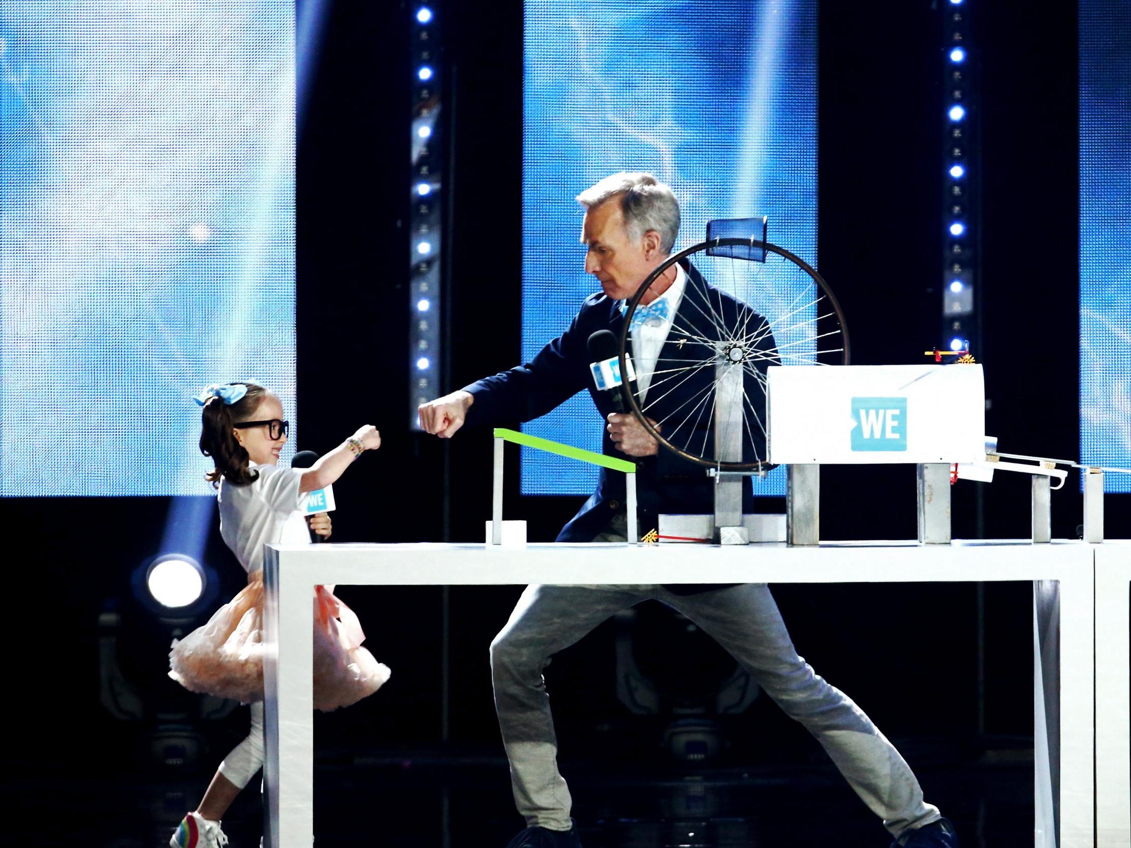 Bill Nye (right) and Brielle Milla (left) speak onstage at WE Day California at The Forum on April 25, 2019 in Inglewood, California.