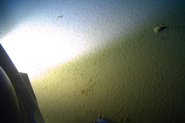 Manmade rubbish, top right, is seen on the floor of the Mariana Trench - the deepest point of the world's oceans