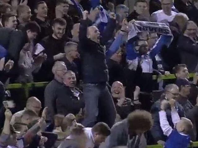 Referee Mike Dean celebrates Tranmere's victory over Forest Green Rovers