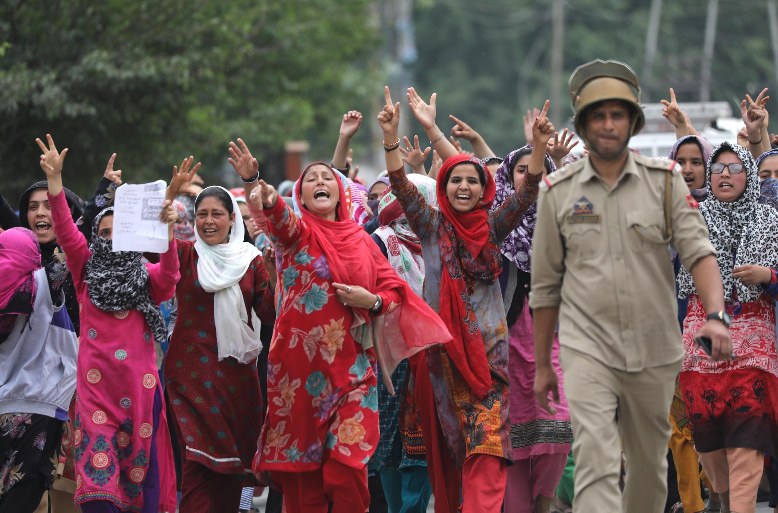 Female Kashmiri Muslim protesters shout slogans during a protest on the outskirts of Srinagar in Kashmir