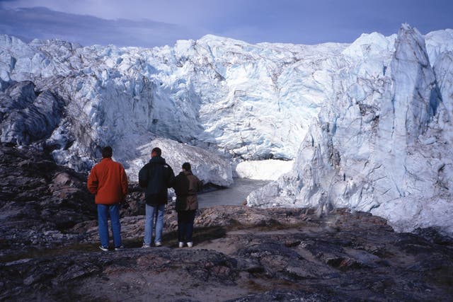 Tourists looking at the Jakobshavn Isbrae glacier in west Greenland