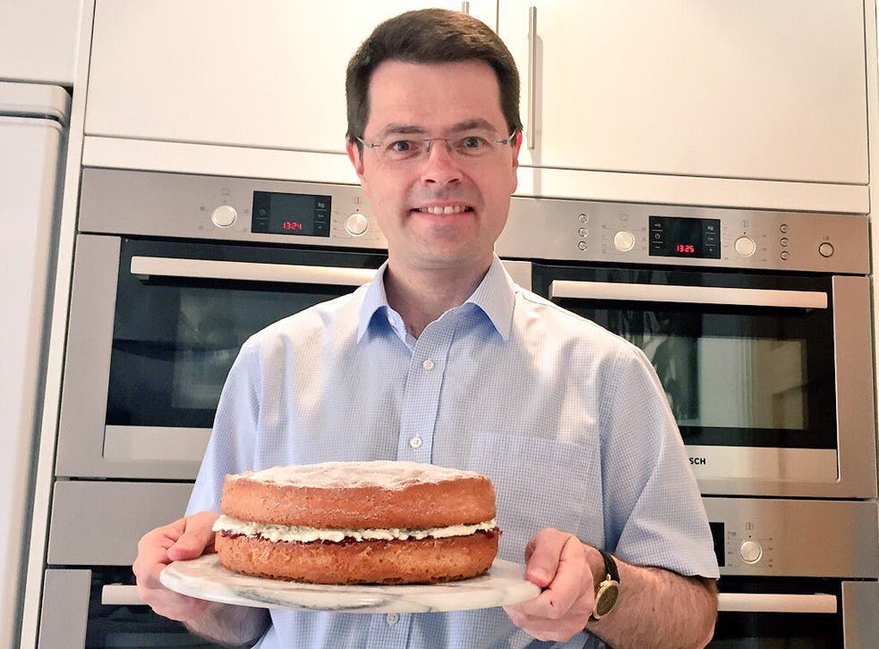 Communities secretary James Brokenshire poses with a Victoria sponge cake in front of his four-door oven set-up