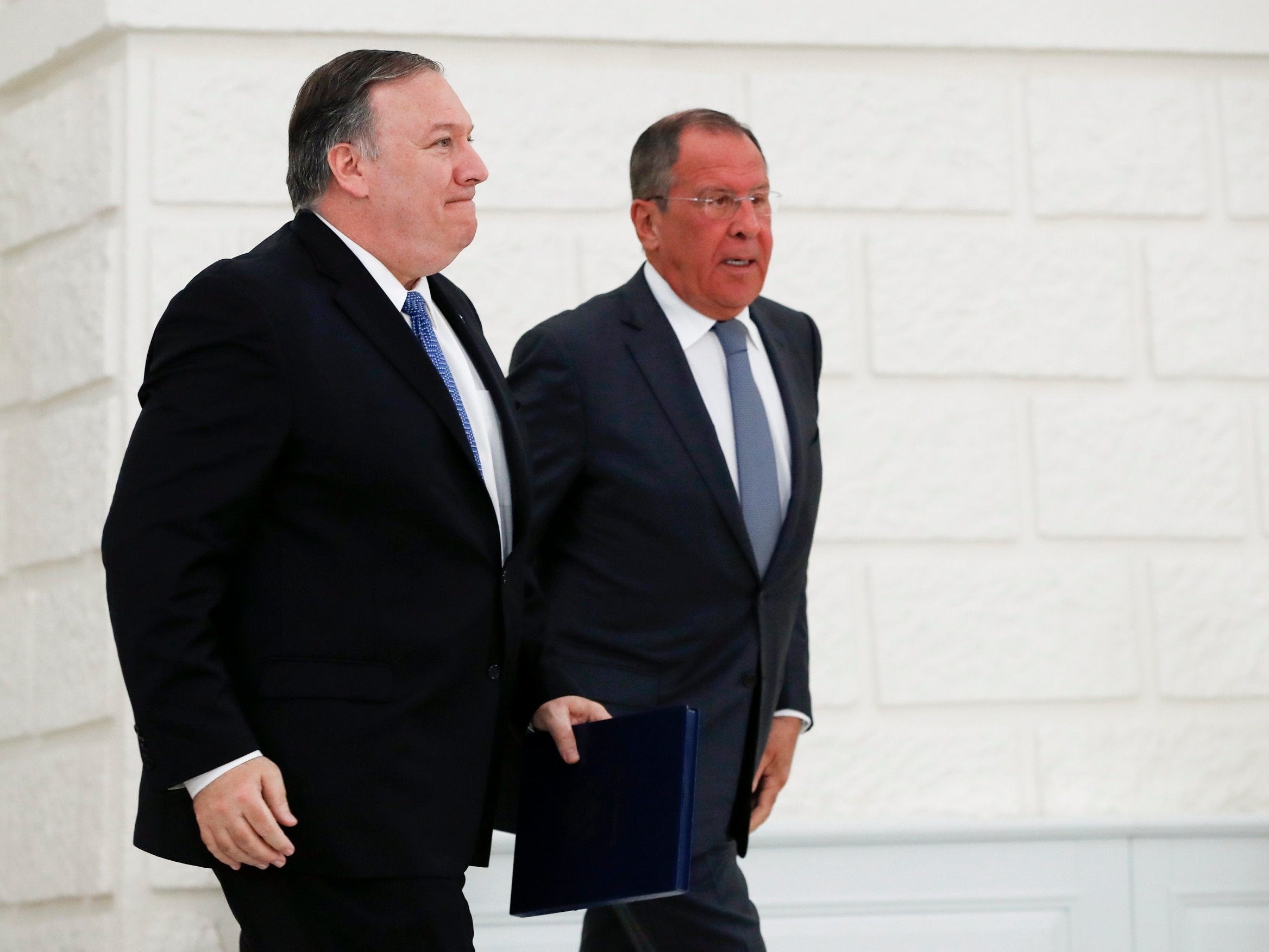 Mike Pompeo and Sergei Lavrov leave after their joint news conference following talks in the Black Sea resort city of Sochi