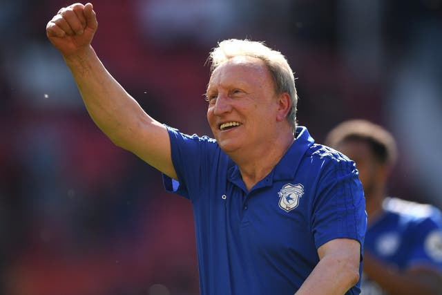Cardiff manager Neil Warnock celebrates with the fans