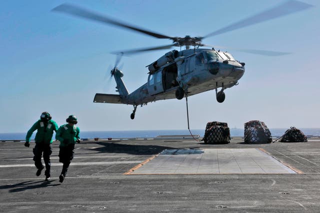 A US Navy helicopter takes off from the USS USS Abraham Lincoln aircraft carrier, which has been deployed to the Gulf as the Trump administration ratchets up pressure on Iran