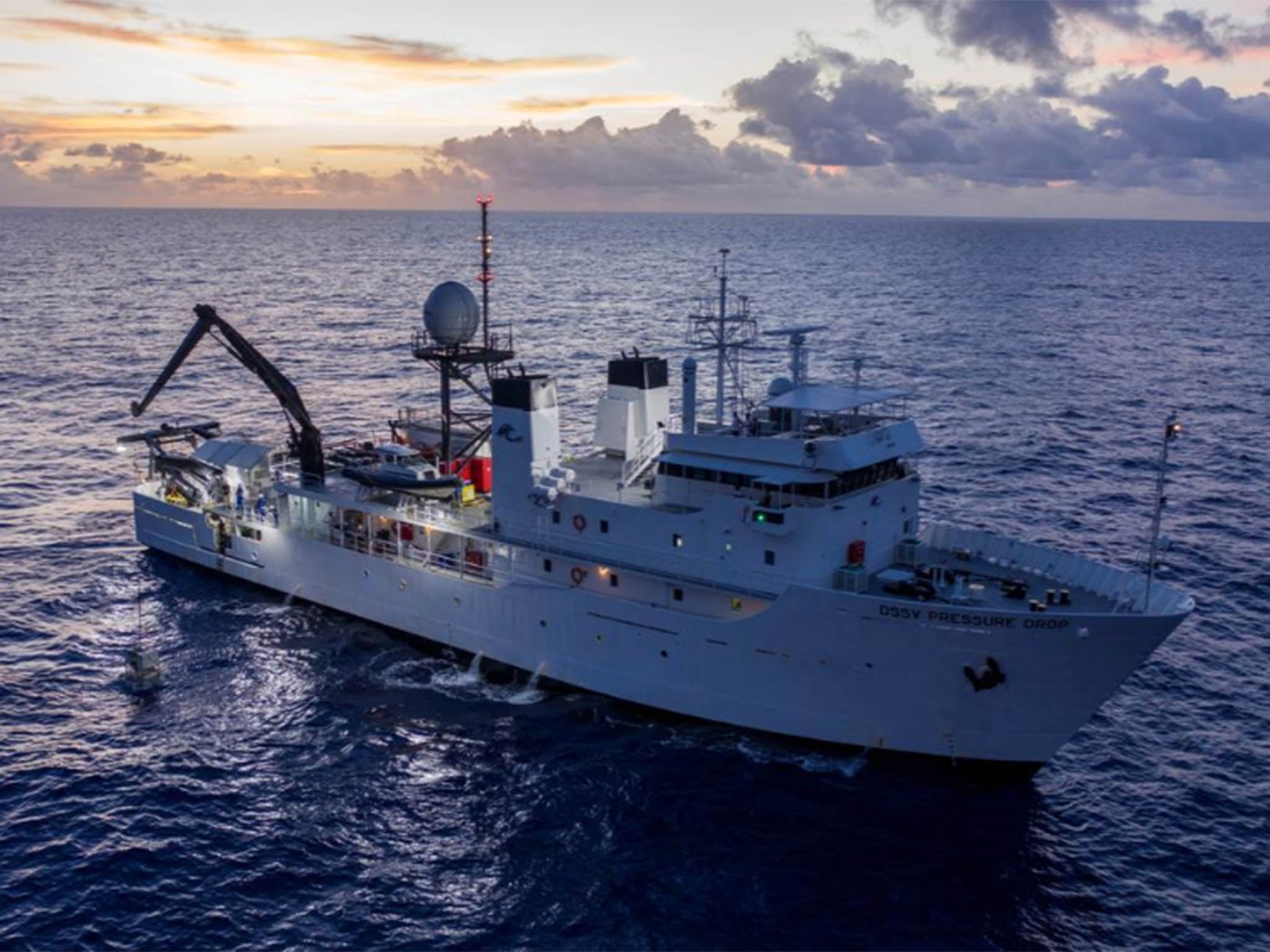 With Vescovo on board, the submarine is tethered to a crane before being dropped into the ocean