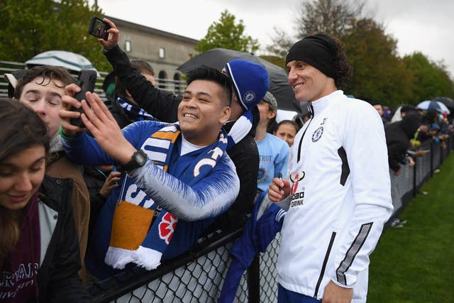 David Luiz of Chelsea signs autographs after a training session