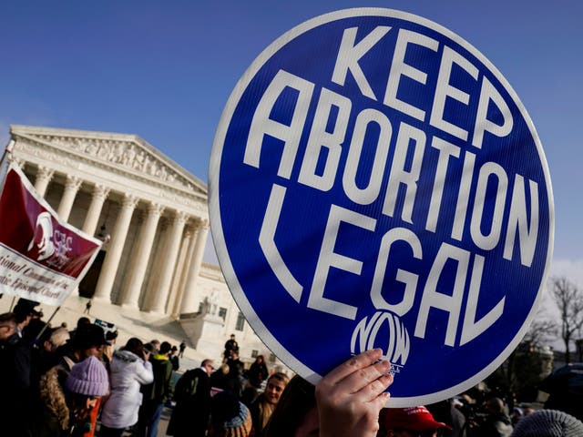 An abortion rights activist holds up a sign as marchers take part in the 46th annual March for Life in Washington