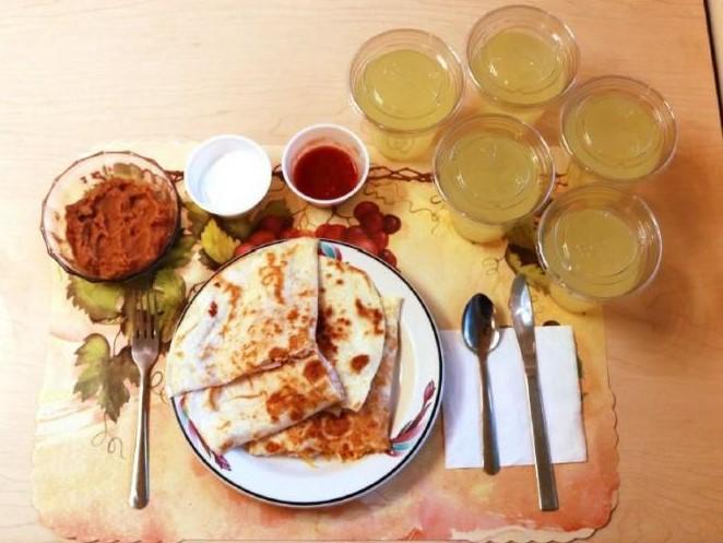 A typical processed lunch, consisting of quesadillas, refried beans, and diet lemonade.