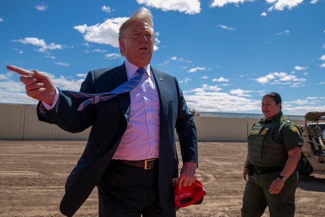 President Donald Trump speaks as he visits a new section of the border wall with Mexico in Calexico, California