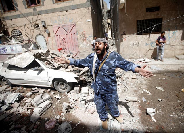 A Houthi security officer at the site of an airstrike launched by the Saudi-led coalition in Sana’a