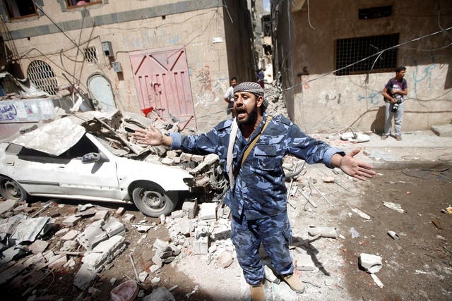 A Houthi security officer at the site of an airstrike launched by the Saudi-led coalition in Sana’a