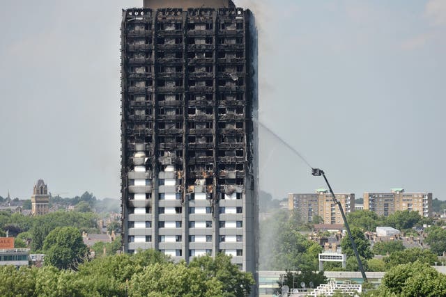Firefighters spraying water after the blaze engulfed Grenfell Tower in west London