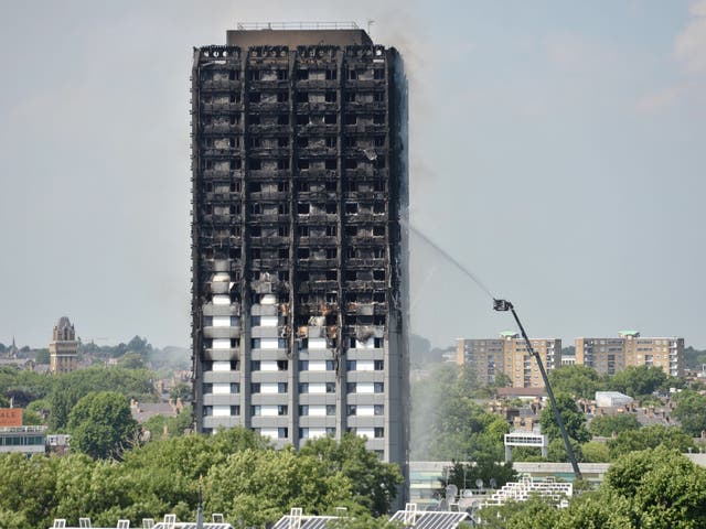 Firefighters spraying water after the blaze engulfed Grenfell Tower in west London