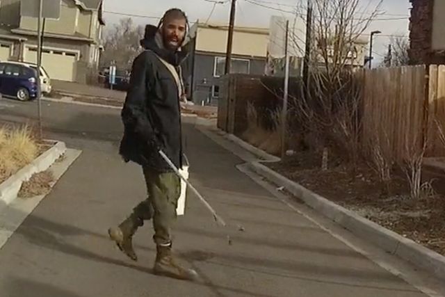 A screenshot of Officer John Smyly's body camera footage, released by the City of Boulder, depicting Zayd Atkinson picking up garbage.