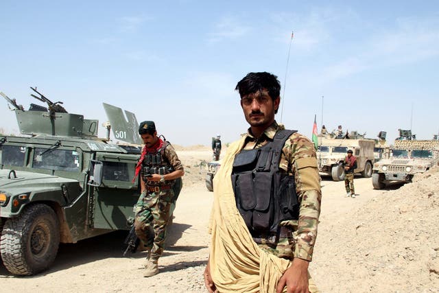 Afghan security officials on patrol in Helmand province, Afghanistan, on Friday
