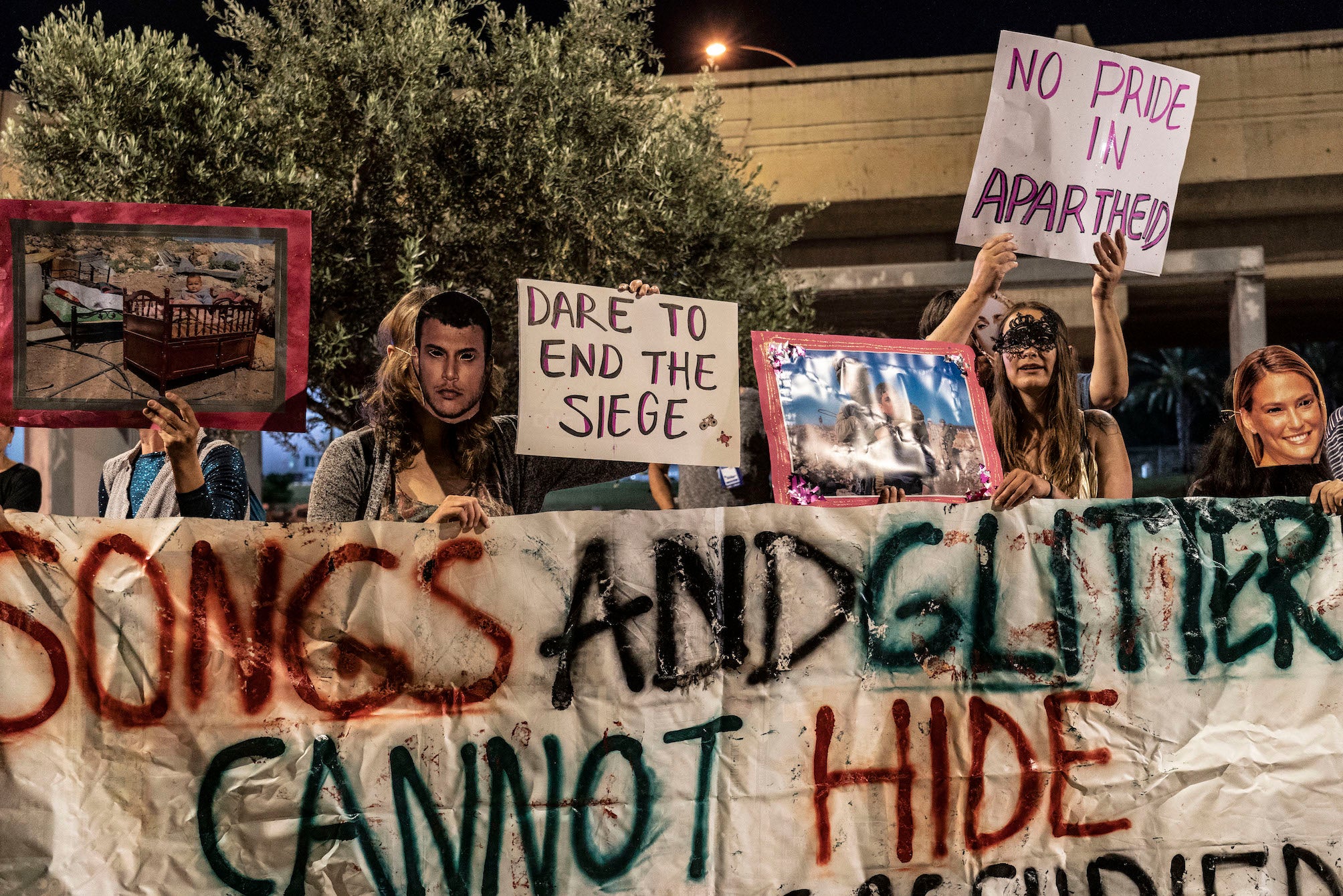 Protesters chant “songs and glitter cannot hide homeland being occupied” outside Tel Aviv’s expo centre for Eurovision