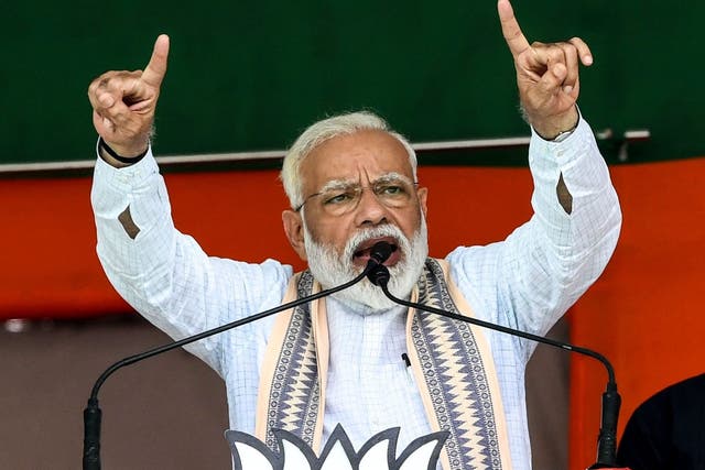 Indian Prime Minister Narendra Modi gestures as he speaks to political supporters during an election rally in Muzaffarpur in the eastern state of Bihar
