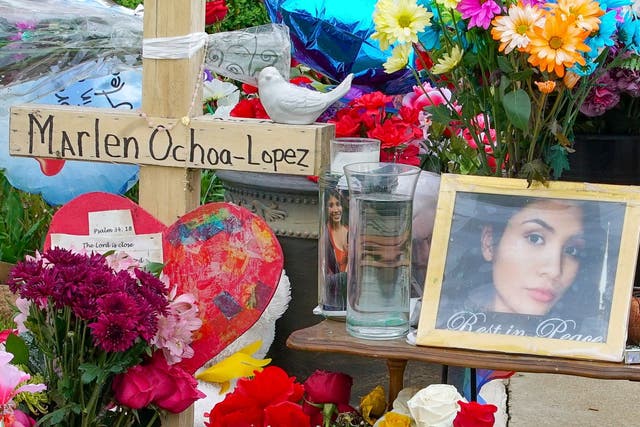 A memorial of flowers, balloons, a cross and photo of victim Marlen Ochoa-Lopez, are displayed on the lawn
